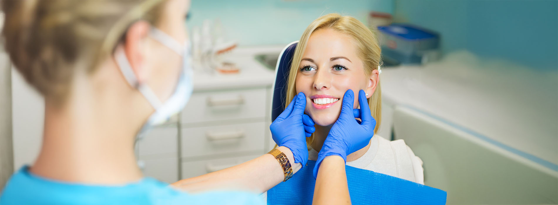 A woman receiving dental care from a professional, with a focus on cleanliness and hygiene.