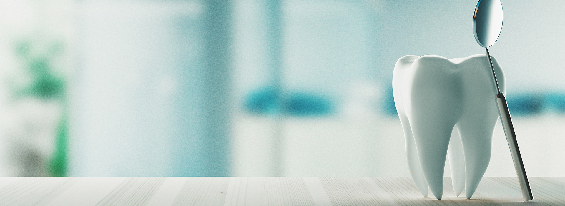 The image shows a toothbrush with bristles placed on a countertop against a blurred background featuring what appears to be dental equipment and a person s arm, suggesting a dental office setting.